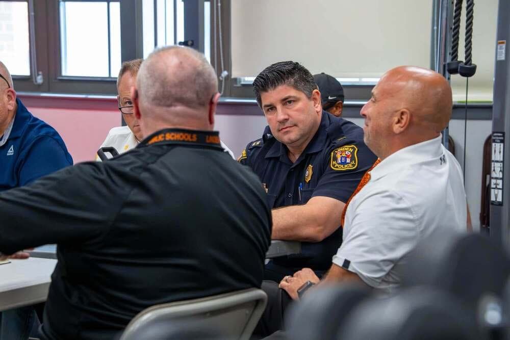 Participants discuss coordinated emergency response during Linden Public Schools' tabletop exercise at Tiger Stadium at Cooper Field.