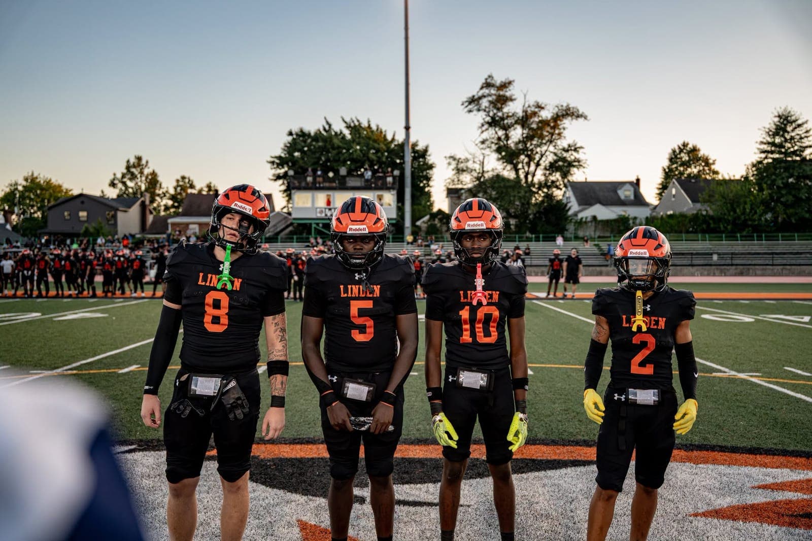 Linden captains gather at midfield before the game.