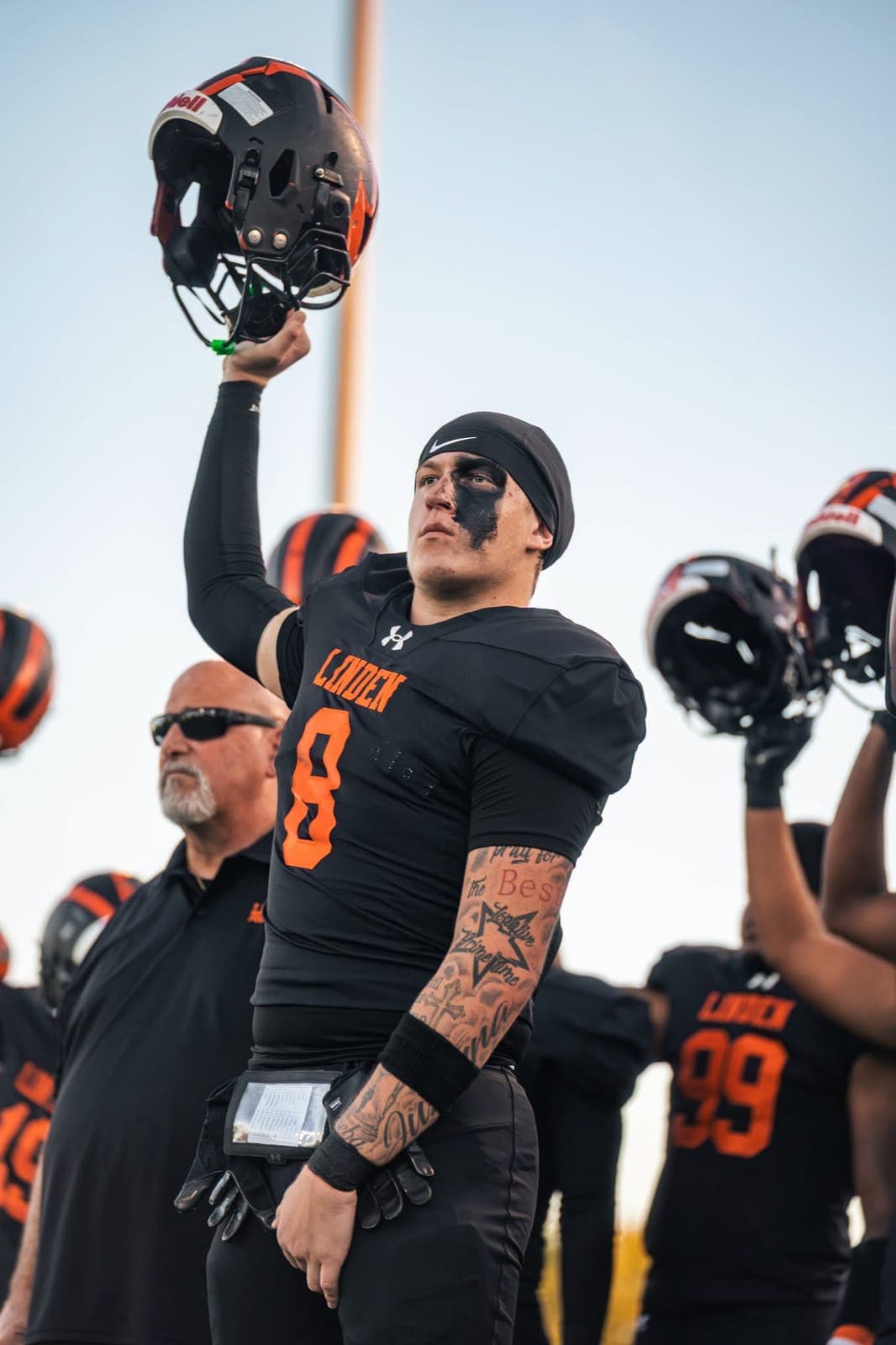 A Linden Tiger raises his helmet during pregame introductions.